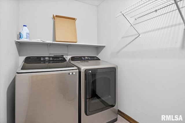 clothes washing area with washer and clothes dryer