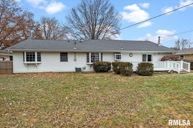 rear view of house featuring a deck, a lawn, and central air condition unit