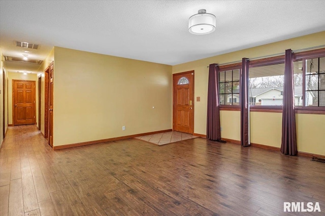 entryway featuring hardwood / wood-style floors and a textured ceiling