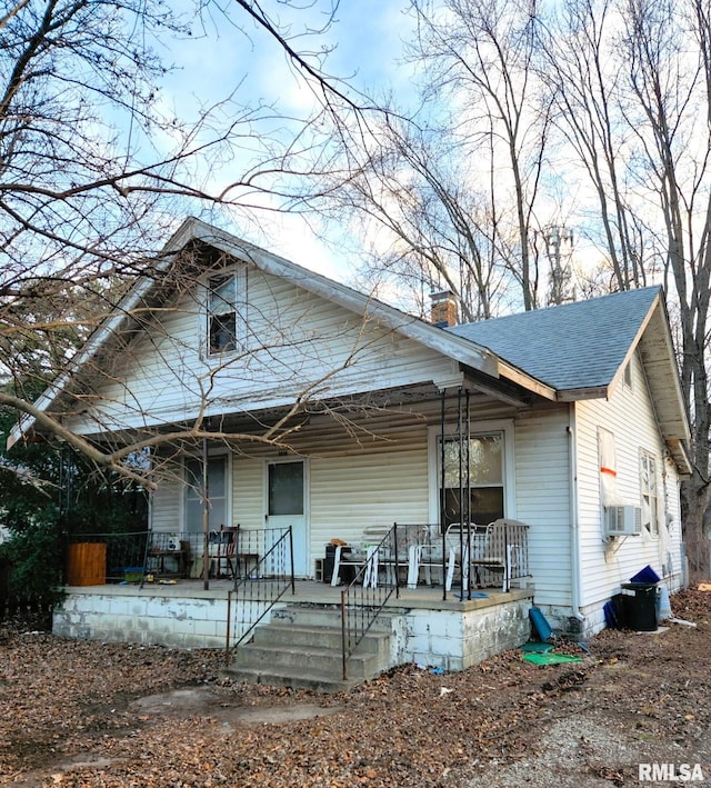 bungalow-style house featuring cooling unit and a porch