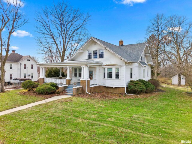 view of front facade with covered porch and a front lawn