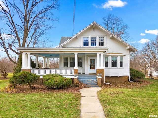 view of front of house with covered porch and a front yard