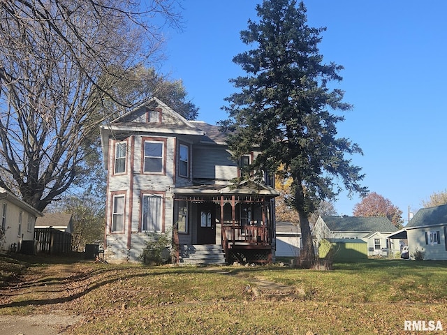 victorian home featuring a front yard and covered porch