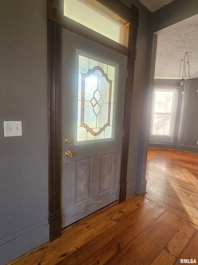 foyer featuring hardwood / wood-style floors and a textured ceiling