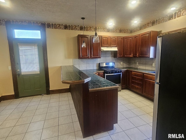 kitchen with kitchen peninsula, decorative backsplash, stainless steel appliances, light tile patterned floors, and pendant lighting