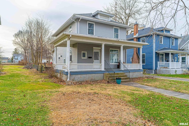 view of front of home with covered porch and a front yard