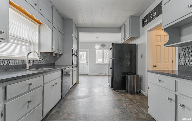 kitchen with gray cabinetry, sink, hanging light fixtures, backsplash, and appliances with stainless steel finishes