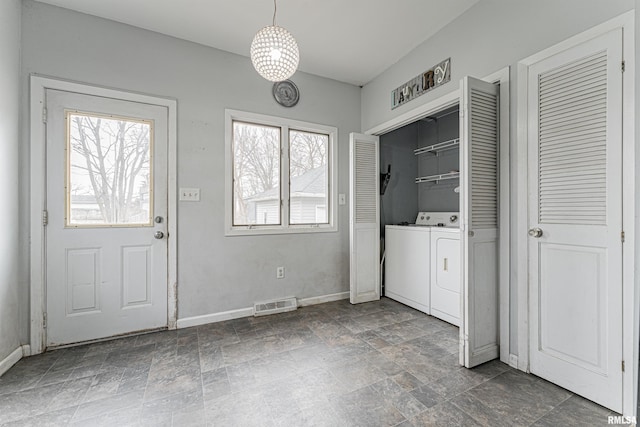 clothes washing area with separate washer and dryer and plenty of natural light