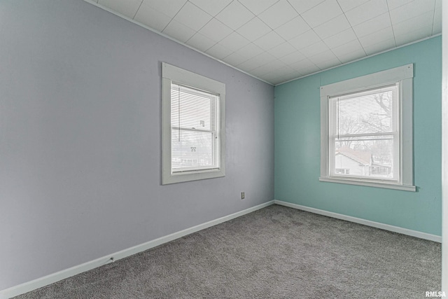 spare room with a healthy amount of sunlight and light colored carpet