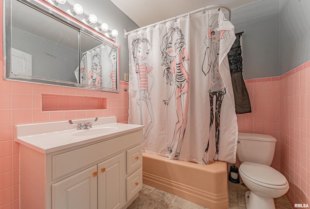 full bathroom with vanity, shower / bath combo, tile walls, and toilet