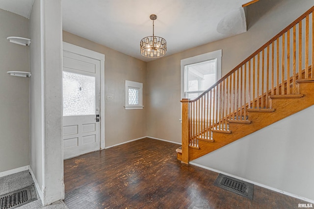 entrance foyer with dark wood-type flooring and a chandelier