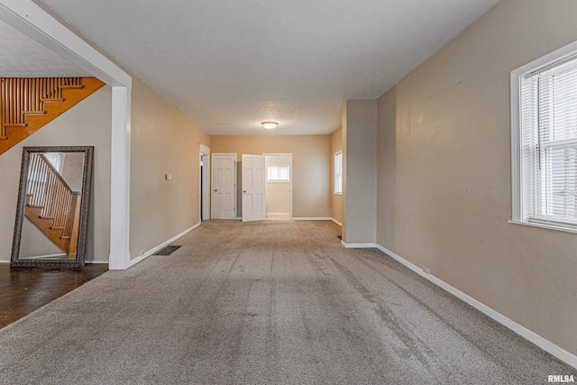 hall featuring carpet floors and a wealth of natural light