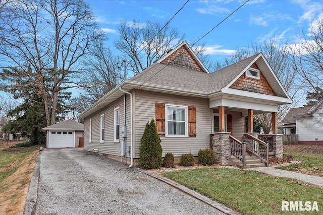 view of front facade featuring covered porch, a garage, and an outdoor structure