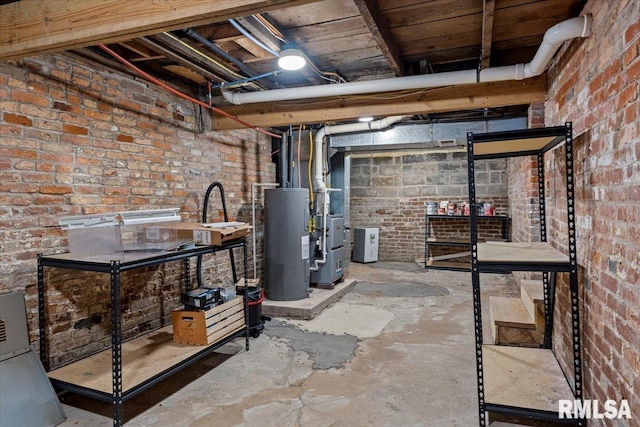 basement with brick wall and electric water heater