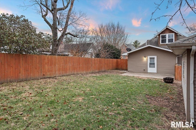 yard at dusk with a patio area