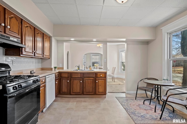 kitchen featuring backsplash, black range with gas cooktop, extractor fan, sink, and dishwasher