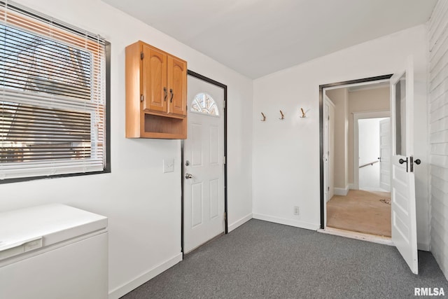 clothes washing area with dark carpet