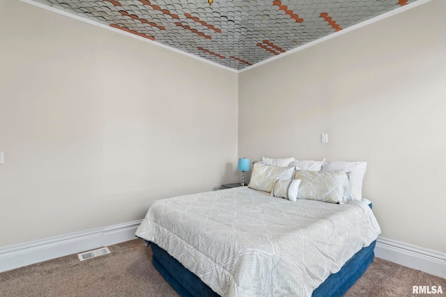 bedroom featuring crown molding and carpet floors