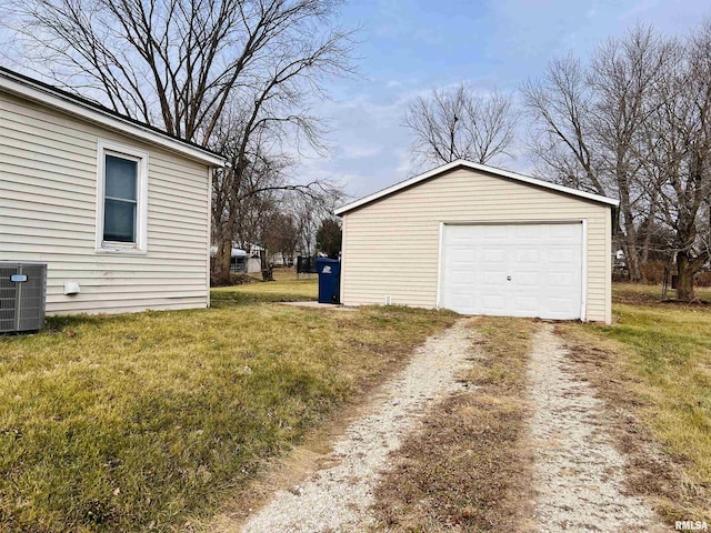 garage with central AC and a lawn