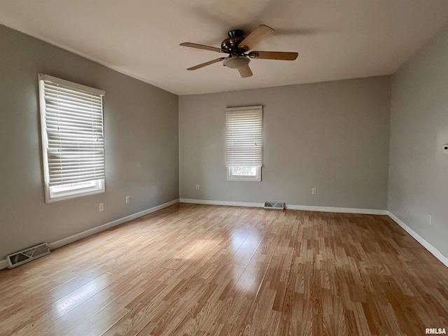 empty room with light wood-type flooring and ceiling fan