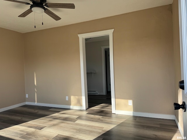 unfurnished room featuring ceiling fan, wood-type flooring, and a baseboard radiator