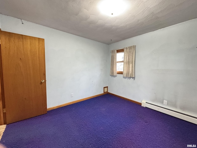 carpeted empty room featuring a textured ceiling and a baseboard heating unit