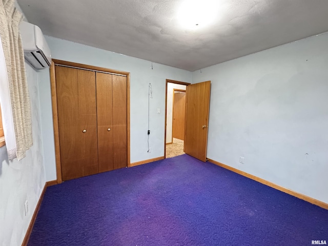 unfurnished bedroom with a wall mounted air conditioner, dark carpet, and a closet