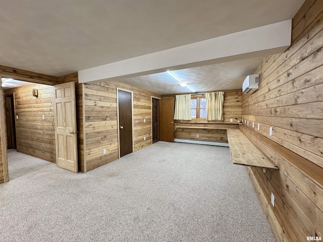 basement with carpet flooring, a wall unit AC, wooden walls, and a baseboard heating unit