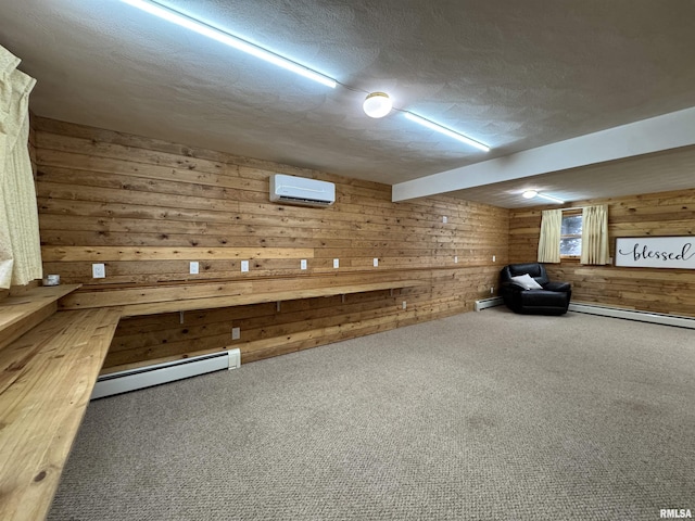 basement featuring carpet flooring, a textured ceiling, a wall unit AC, baseboard heating, and wooden walls