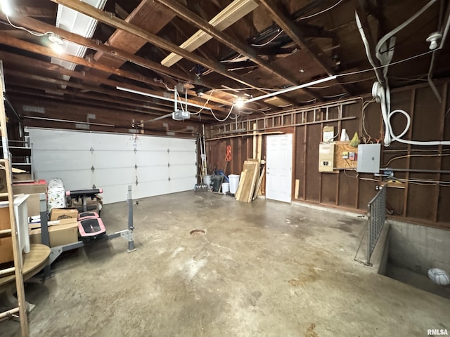 garage featuring electric panel and a garage door opener