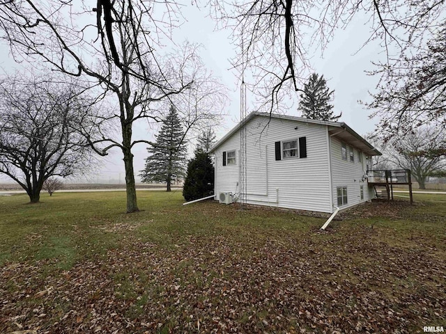 view of home's exterior with a yard and a deck