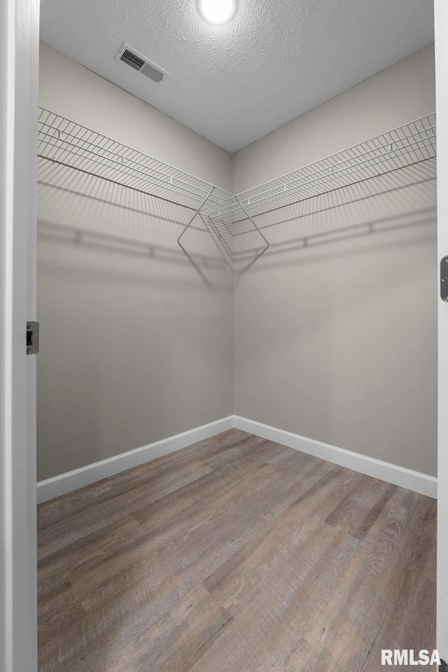 spacious closet featuring hardwood / wood-style flooring