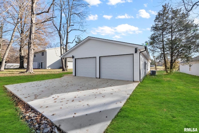 garage featuring a yard and central air condition unit