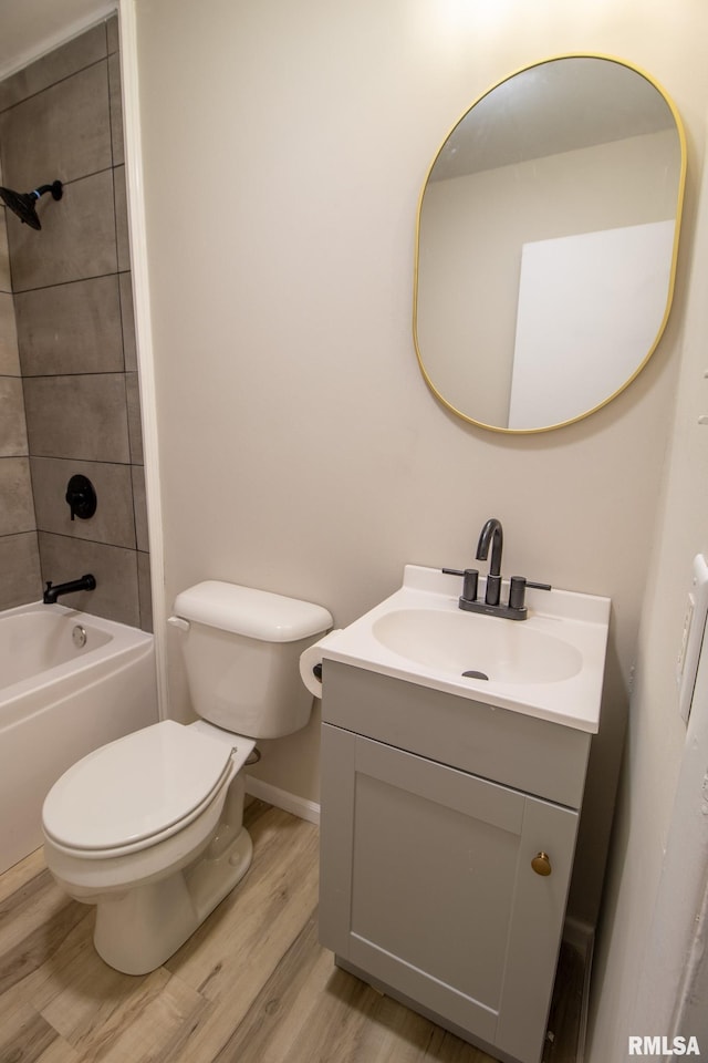 full bathroom featuring wood-type flooring, vanity, toilet, and tiled shower / bath combo