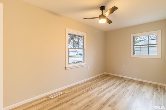 unfurnished room featuring light wood-type flooring, a wealth of natural light, and ceiling fan