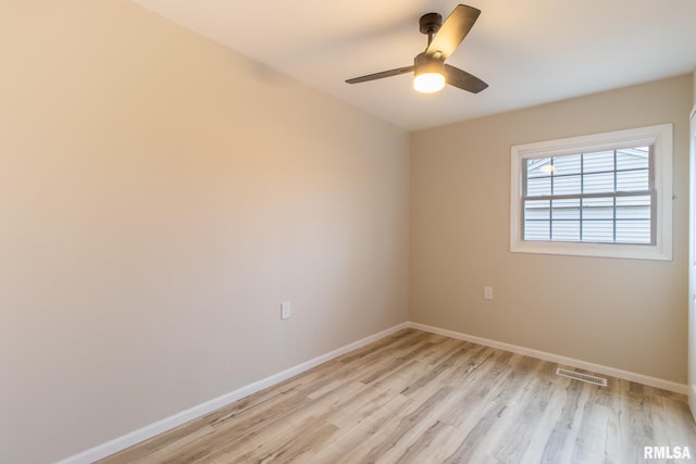 empty room featuring ceiling fan and light hardwood / wood-style floors