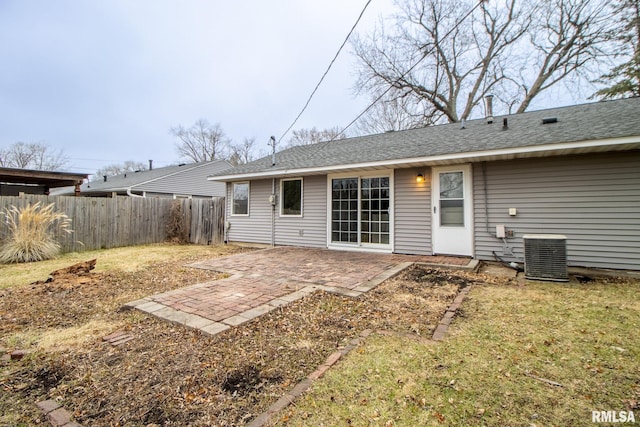 back of property with a yard, a patio area, and central air condition unit