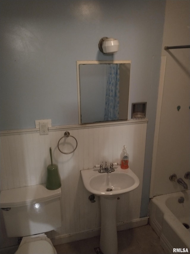 bathroom with tile patterned flooring, toilet, and tub / shower combination