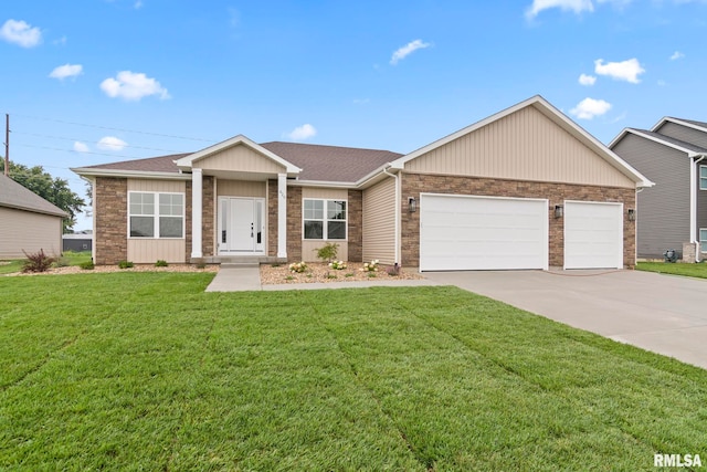 view of front of home featuring a front yard and a garage