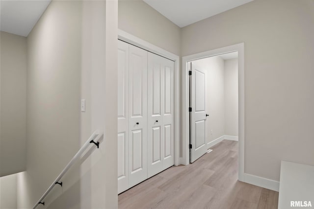 corridor with light hardwood / wood-style floors