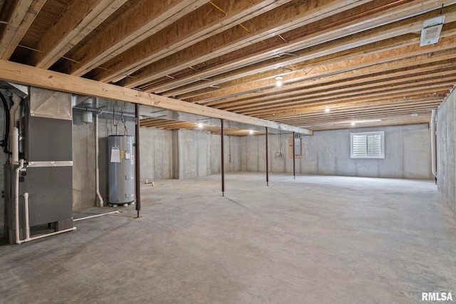 basement featuring heating unit, electric panel, and water heater