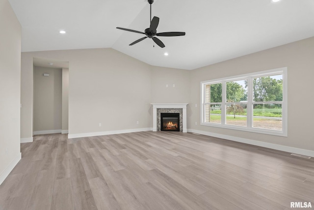 unfurnished living room featuring ceiling fan, light hardwood / wood-style floors, and vaulted ceiling