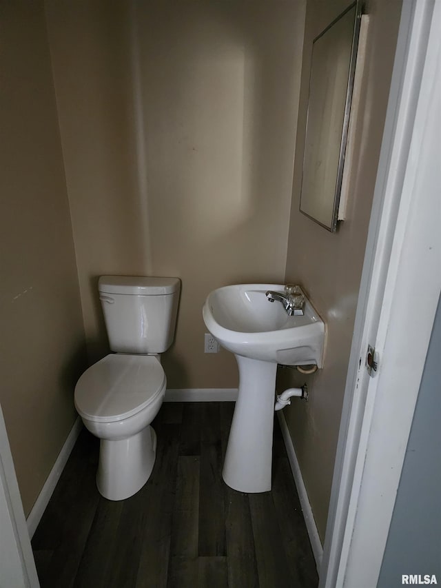 bathroom with toilet and wood-type flooring