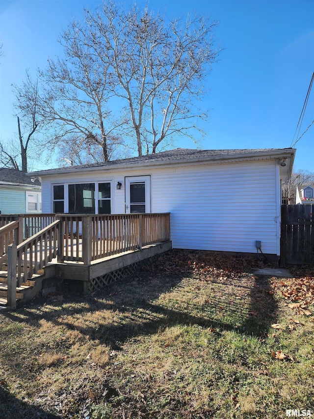 exterior space with a wooden deck and a front yard