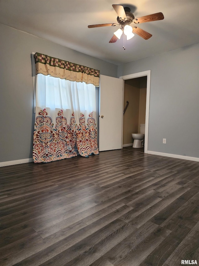 empty room with dark hardwood / wood-style floors and ceiling fan