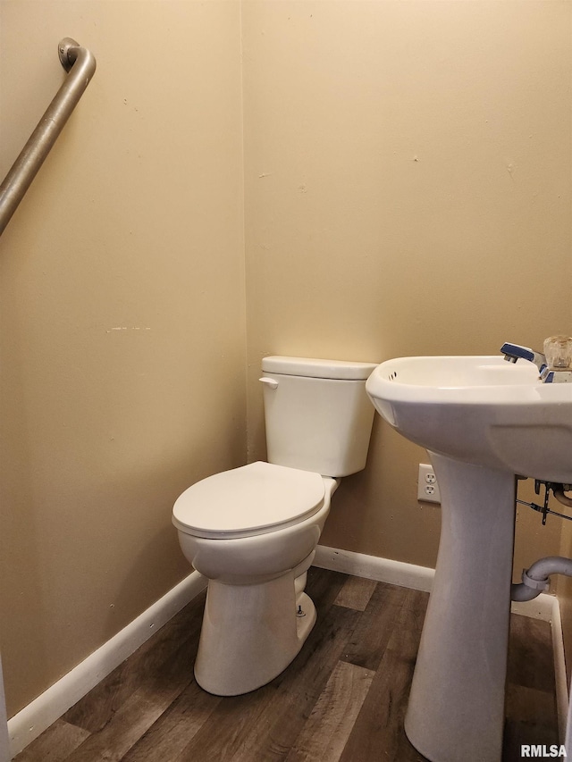 bathroom with toilet and hardwood / wood-style flooring