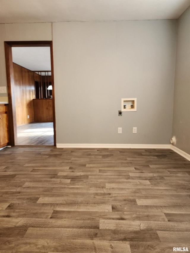 laundry room featuring hookup for a washing machine, hardwood / wood-style flooring, and wood walls