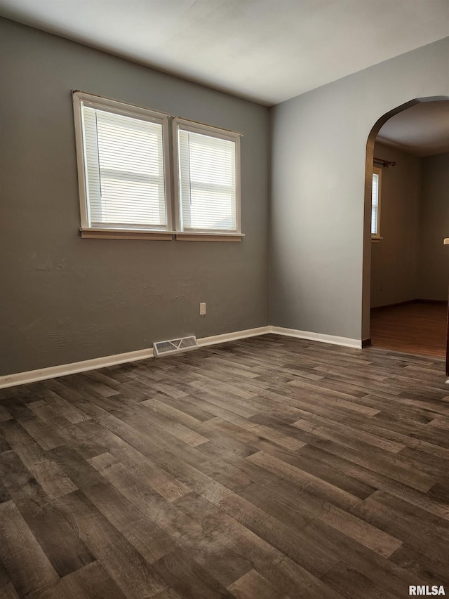 spare room featuring dark hardwood / wood-style floors