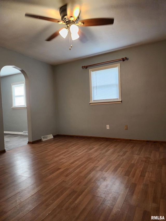 spare room featuring ceiling fan and dark hardwood / wood-style floors