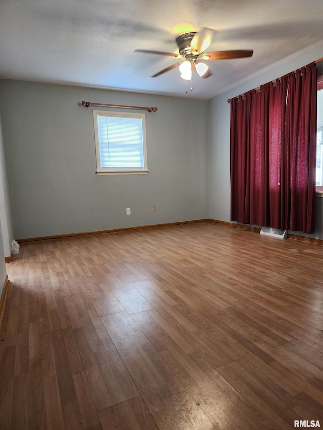 spare room featuring ceiling fan and hardwood / wood-style flooring